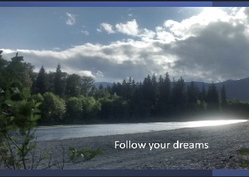 Scenic image of lake with trees and a backdrop of mountains with the text Follow your dreams